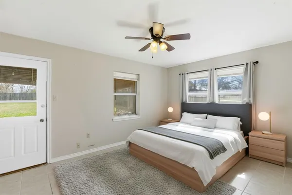 a bedroom with a large bed and a chandelier