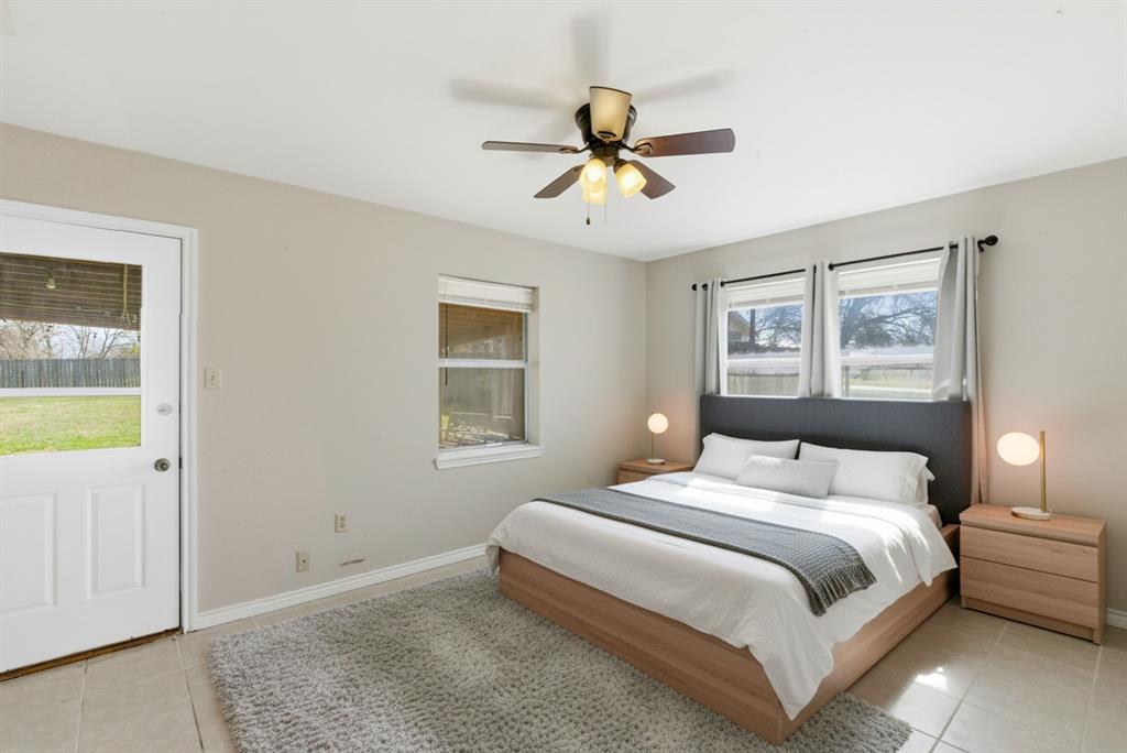 504 North Hall Street Hamilton, TX 76531 - Photo 18 of 31 a bedroom with a large bed and a chandelier