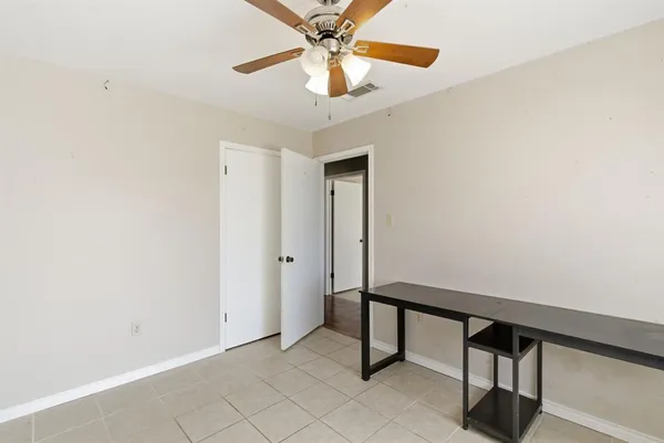 a view of entryway with a chandelier fan