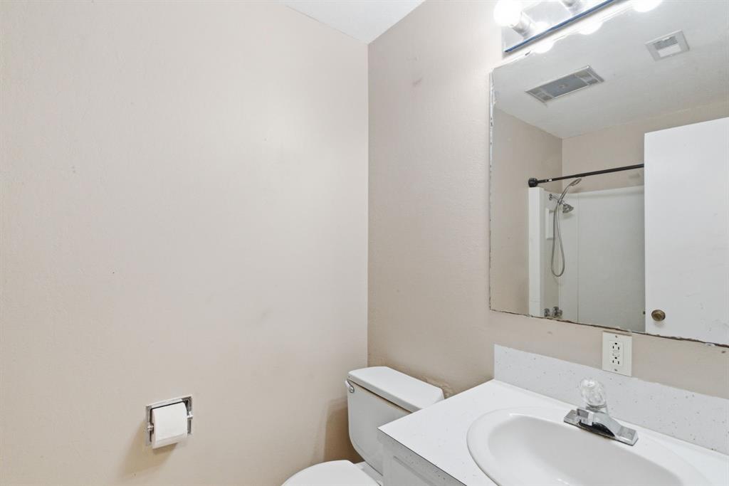 504 North Hall Street Hamilton, TX 76531 - Photo 23 of 31 a bathroom with a sink mirror and toilet