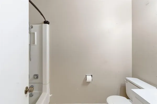 a white toilet sitting next to a bathroom sink