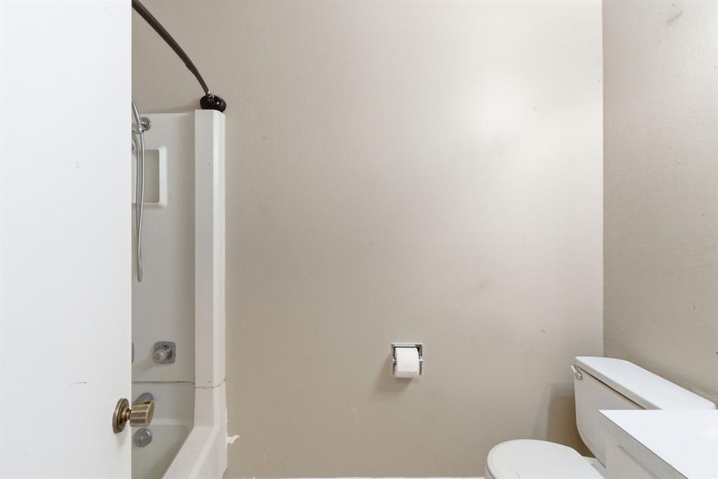 504 North Hall Street Hamilton, TX 76531 - Photo 24 of 31 a white toilet sitting next to a bathroom sink