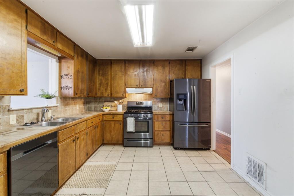 504 North Hall Street Hamilton, TX 76531 - Photo 10 of 31 a kitchen with stainless steel appliances granite countertop a refrigerator and a sink