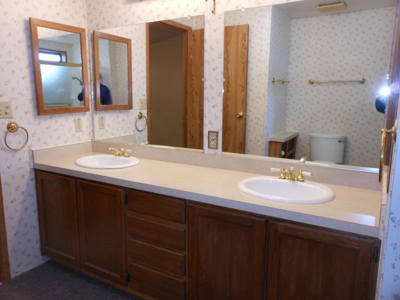 10073 Dalewood Way Grass Valley, CA 95949 - Photo 13 of 34 a bathroom with a double vanity sink and a mirror