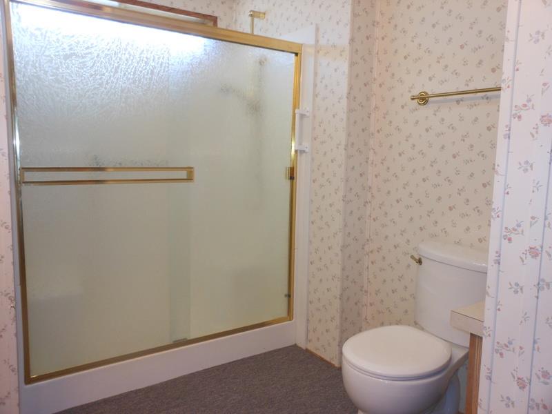 10073 Dalewood Way Grass Valley, CA 95949 - Photo 14 of 34 a white toilet sitting next to a shower