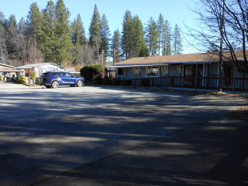 10073 Dalewood Way Grass Valley, CA 95949 - Photo 21 of 34 a front view of a house with a garden and trees
