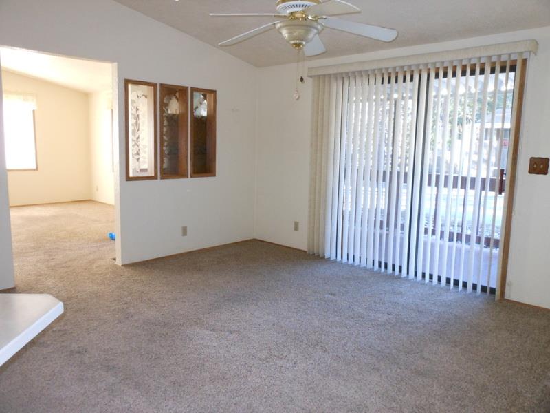 10073 Dalewood Way Grass Valley, CA 95949 - Photo 7 of 34 an empty room with chandelier fan and windows