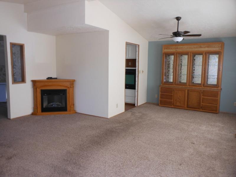 10073 Dalewood Way Grass Valley, CA 95949 - Photo 8 of 34 an empty room with furniture and a fireplace