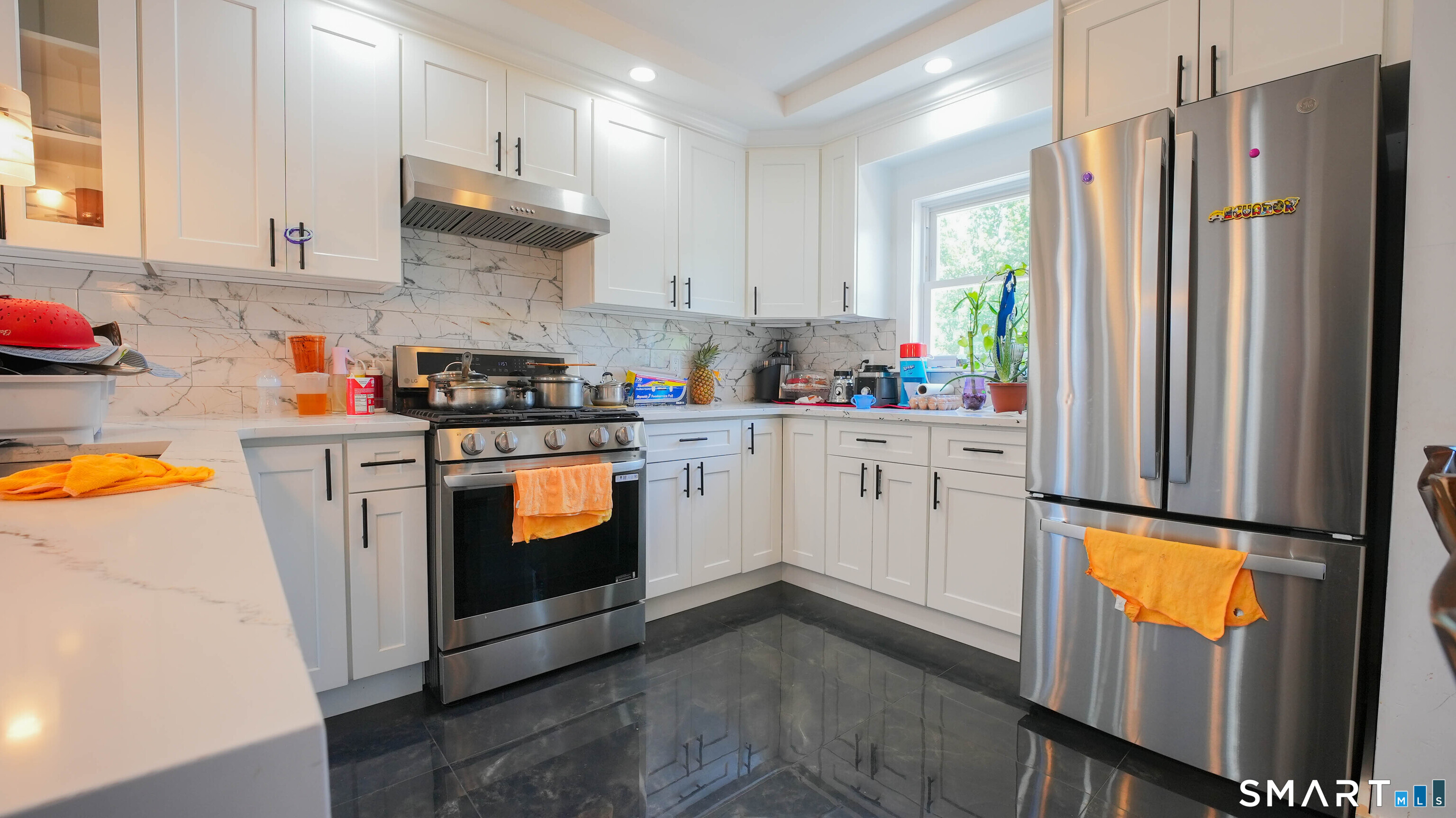 849 Frost Road Waterbury, CT 06705 - Photo 4 of 36 a kitchen with stainless steel appliances white cabinets sink and a refrigerator