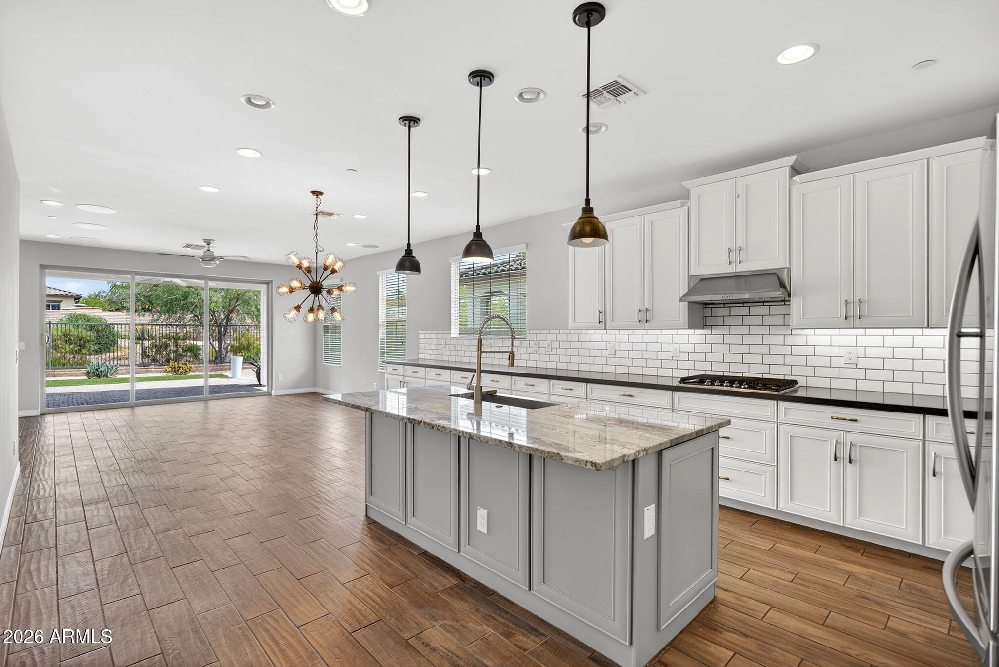 12124 West Peak View Road Peoria, AZ 85383 - Photo 2 of 38 a kitchen with stainless steel appliances granite countertop a sink a stove a oven a counter space and cabinets