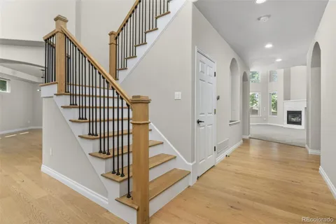 a view of entryway and hall with wooden floor