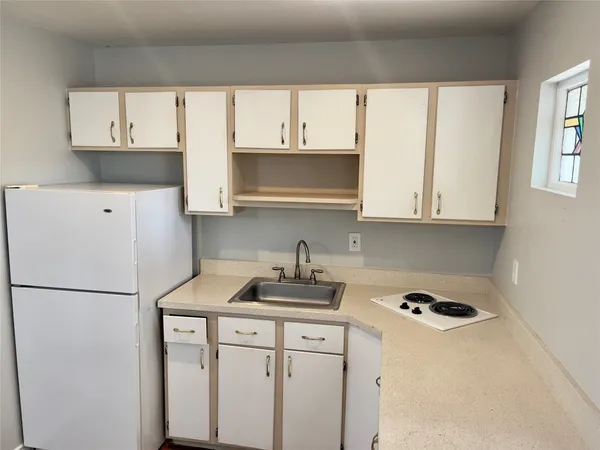 a kitchen with stainless steel appliances granite countertop a refrigerator sink and cabinets
