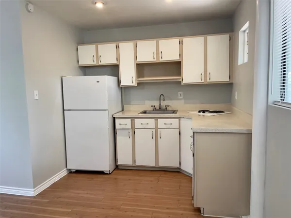 a kitchen with a refrigerator sink stove and cabinets