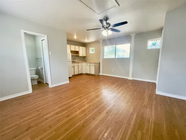 a view of empty room with wooden floor