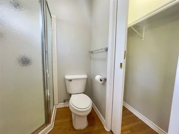 a bathroom with a toilet and a shower