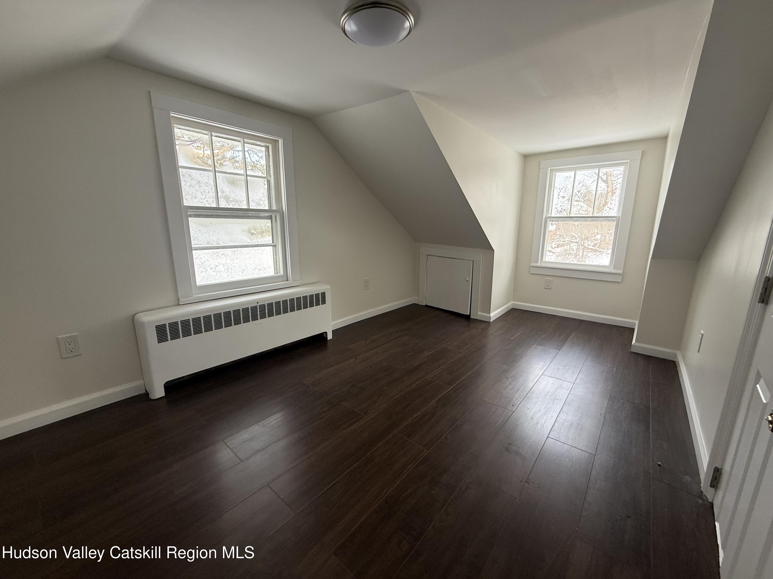 222 Zandhoek Road Hurley, NY 12443 - Photo 14 of 23 an empty room with wooden floor and windows