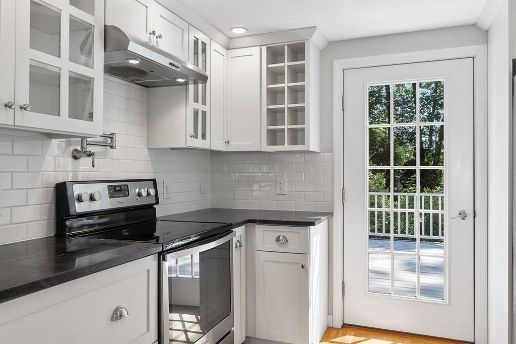 130 Monsen Road Concord, MA 01742 - Photo 12 of 26 a kitchen with stainless steel appliances granite countertop a stove and a white cabinets