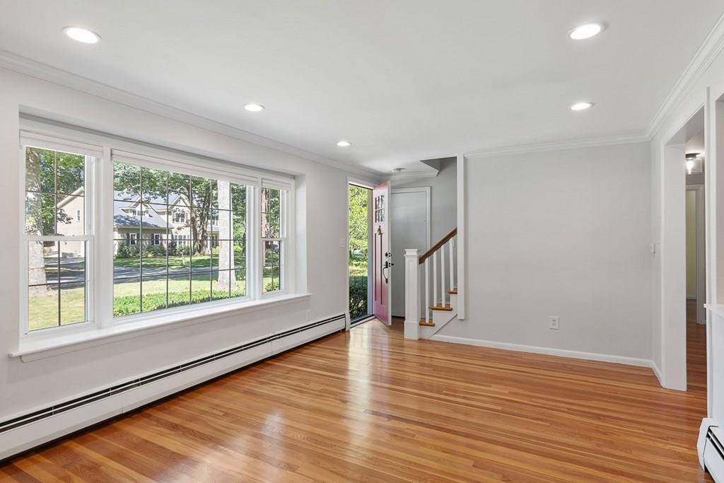 130 Monsen Road Concord, MA 01742 - Photo 9 of 26 a view of empty room with wooden floor and fan