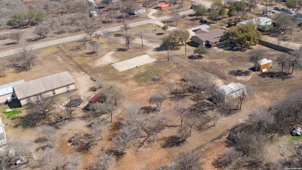 an aerial view of residential houses with outdoor space