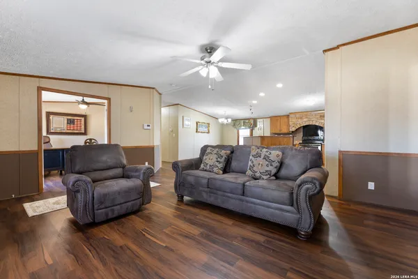 a living room with furniture and a wooden floor