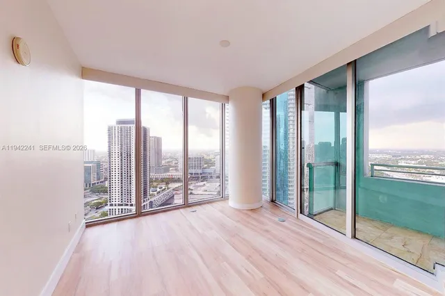 a view of a room with wooden floor and windows