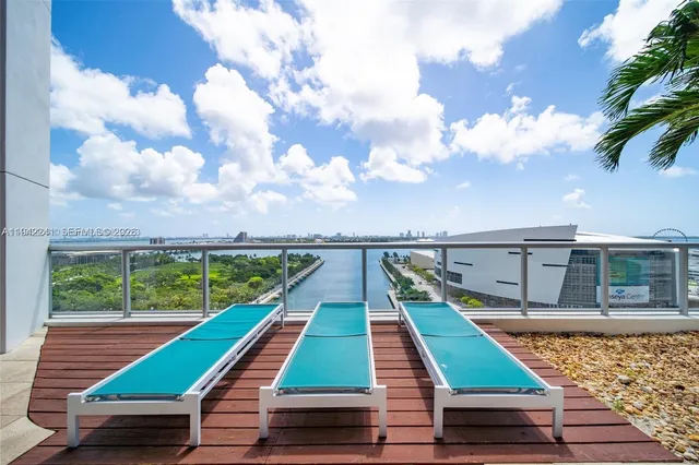 a swimming pool with outdoor seating and yard
