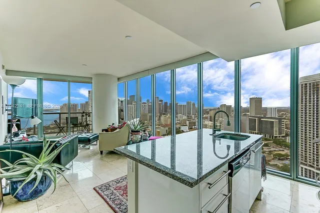 a table with view of living room with furniture and garden view