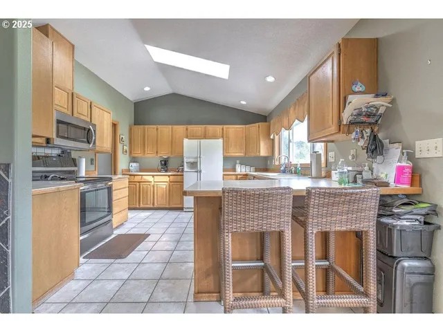 a kitchen with counter top space appliances and cabinets