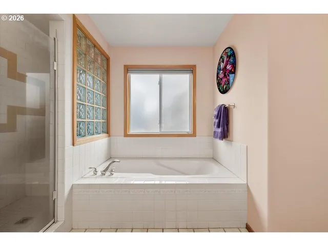 a bathroom with a bathtub and a shower