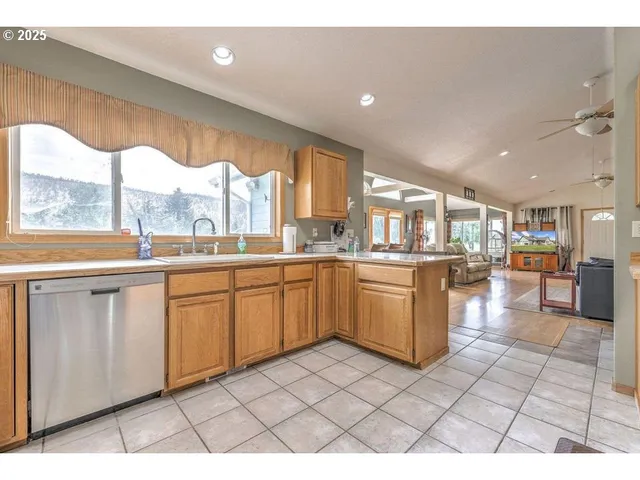 a kitchen with a sink window and cabinets