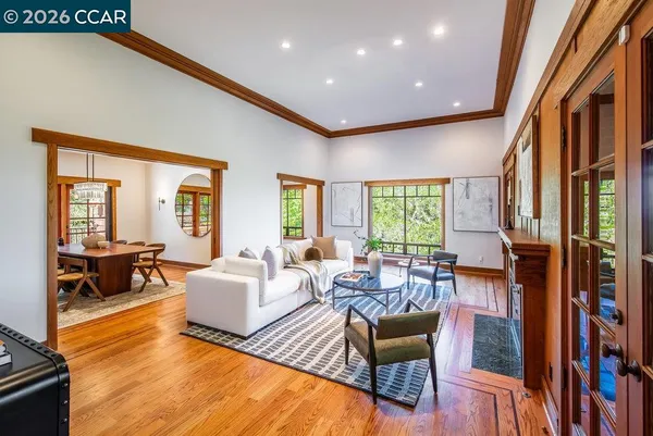 a living room with furniture fireplace and a large window