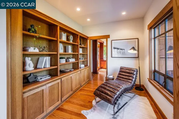 a hallway with cabinets and book shelf