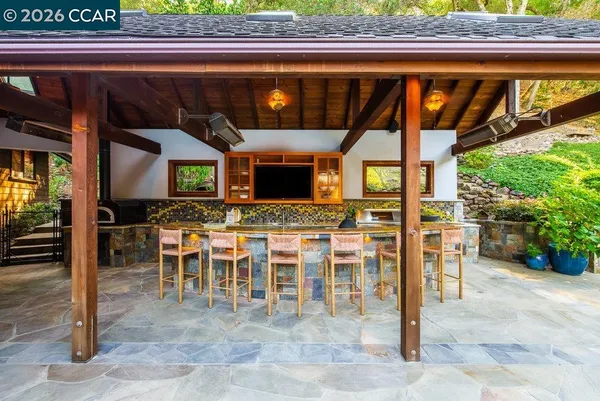 a swimming pool with outdoor seating and yard