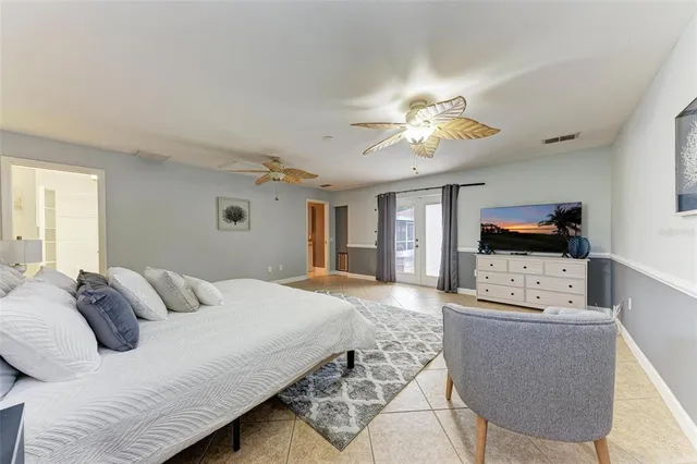 a bedroom with a bed and a chandelier