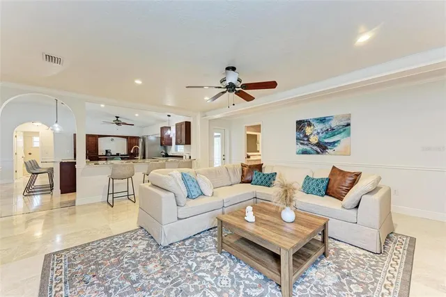 a living room with furniture a rug and a chandelier
