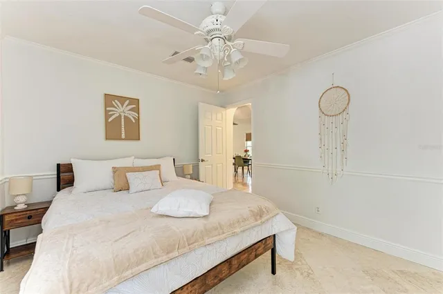 a bedroom with a large bed and a chandelier