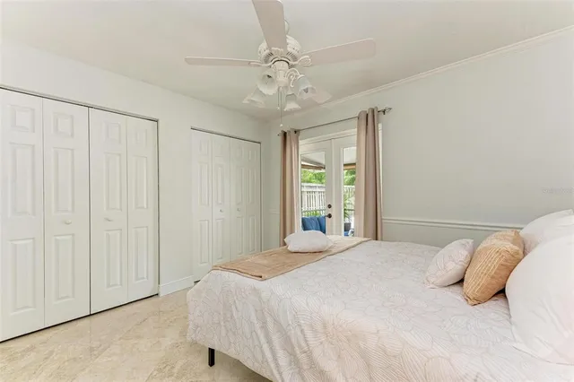 a bedroom with a large bed and a chandelier