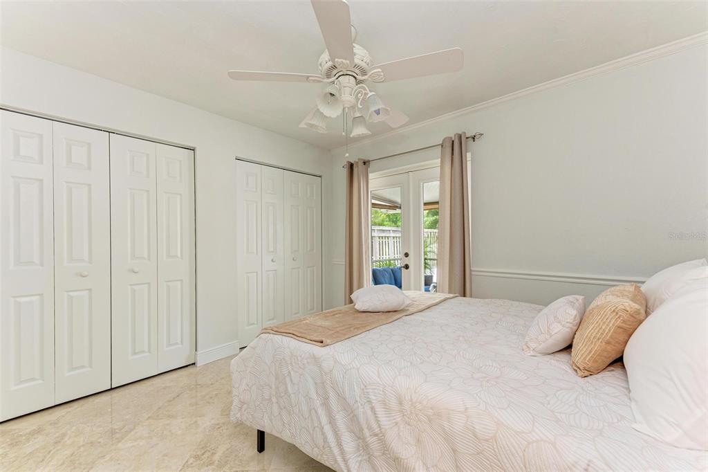 6715 12th Avenue Northwest Bradenton, FL 34209 - Photo 29 of 43 a bedroom with a large bed and a chandelier
