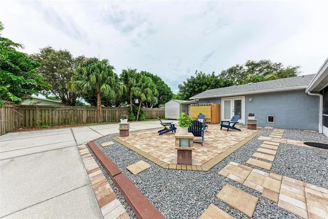 a view of a backyard with sitting area