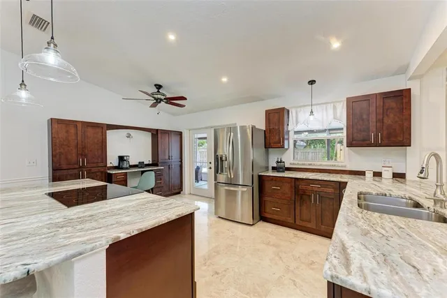 a large kitchen with a large counter top appliances and cabinets