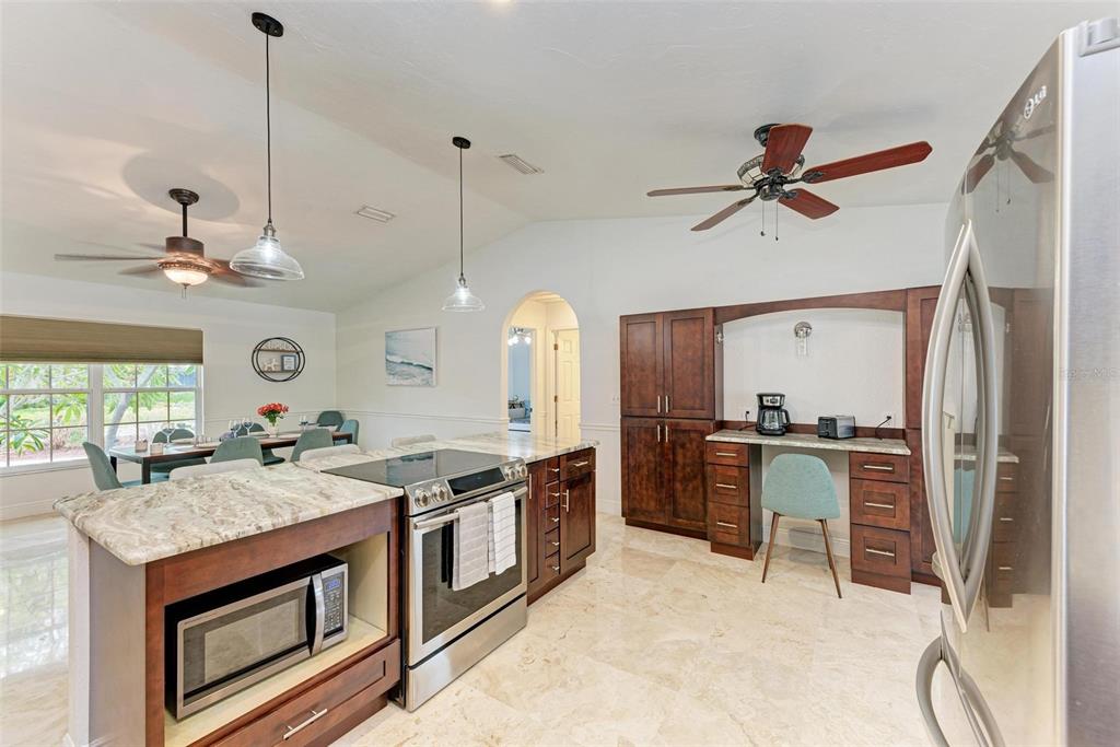 6715 12th Avenue Northwest Bradenton, FL 34209 - Photo 10 of 43 a open kitchen with stainless steel appliances granite countertop a stove and a refrigerator