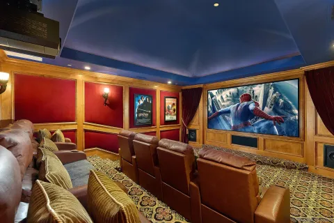 a living room with furniture a flat screen tv and a floor to ceiling window