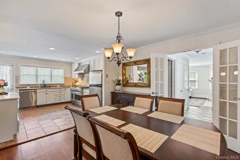 a view of a dining room with furniture and a chandelier