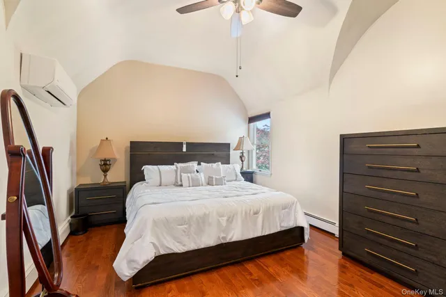 a bedroom with a bed a rug and dresser
