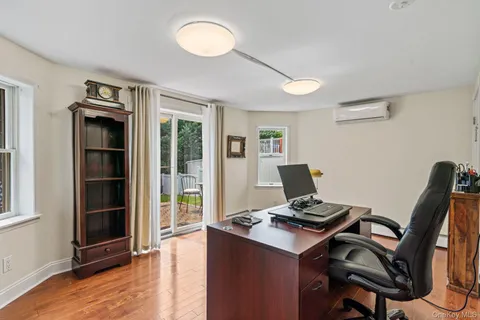 a view of a workspace with furniture and a window