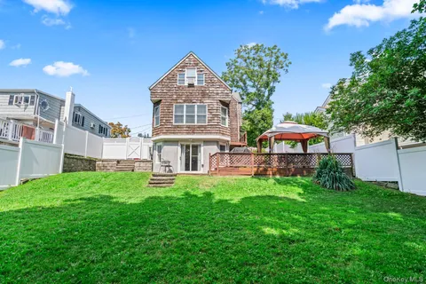 a view of a house with a yard and sitting area