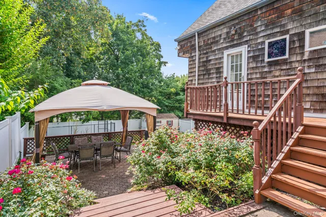 a view of a chair and table in the backyard