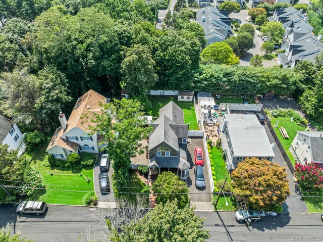 an aerial view of house with yard and outdoor seating