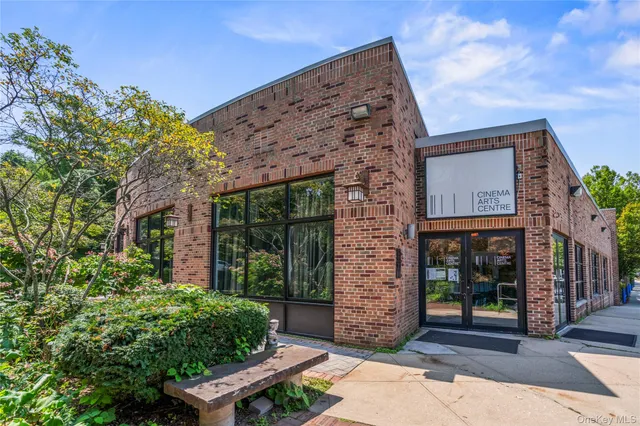 a park view with potted plants and large trees