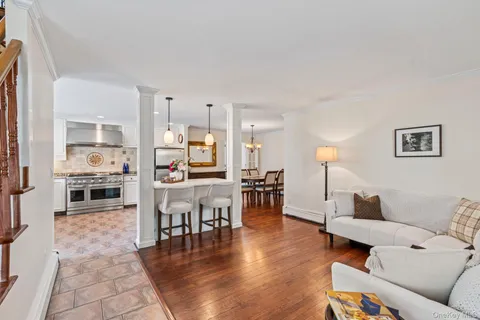 a living room with furniture and kitchen view